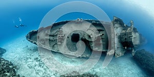 Divers examining the famous USS Kittiwake submarine wreck in the Grand Cayman Islands