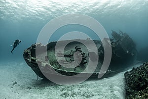 Divers examining the famous USS Kittiwake submarine wreck in the Grand Cayman Islands photo