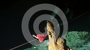 Divers in rocks of underwater cave Yucatan Mexico cenotes.