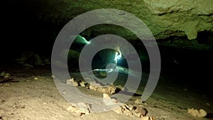 Divers in rocks of underwater cave Yucatan Mexico cenotes.