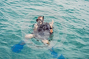 Divers on the surface of water ready to dive