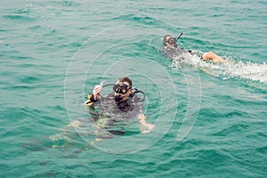 Divers on the surface of water ready to dive