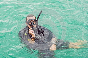 Divers on the surface of water ready to dive