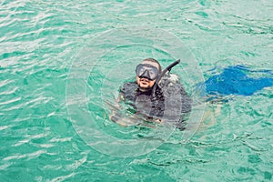 Divers on the surface of water ready to dive