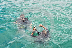 Divers on the surface of water ready to dive