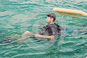 Divers on the surface of water ready to dive