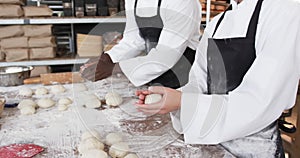 Diverse bakers working in bakery kitchen, making rolls from dough in slow motion