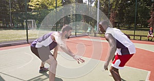 Diverse basketball player practicing one on one game at outdoor court
