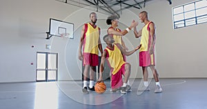 Diverse basketball players celebrate a win on the court