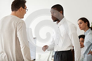 Diverse black employee and white boss arguing at work