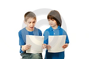 Diverse boys in blue shirts reading