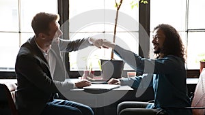 Multi ethnic buddies greeting each other with fists bumping gesture photo