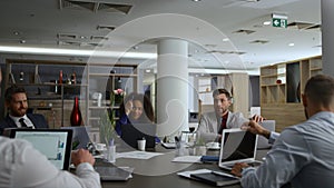 Diverse business group meeting talking financial plan in company office table.