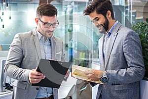 Diverse business men checking available timings for stuff meeting or upcoming company events at office