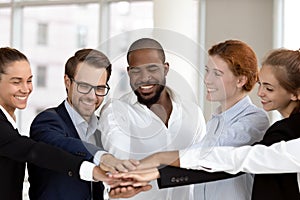 Diverse business people group put hands together in stack pile