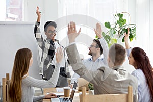 Diverse business people group raise hands at corporate presentation training photo