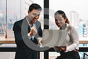 Diverse business people having business conversation during coffee break time with laptop computer and cup of coffee at window