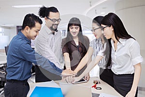 Diverse business people joining hands together