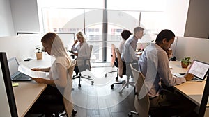 Diverse business people working in office, using computers, workday photo