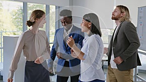 Diverse business team dancing celebrating success in office