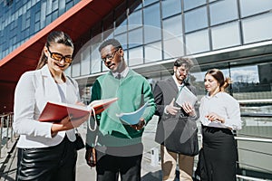 Diverse business team engaged in a meeting outdoors in a sunny city