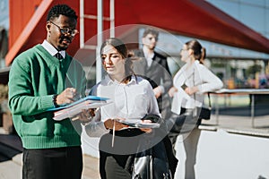 Diverse business team engaging in a strategy discussion outdoors