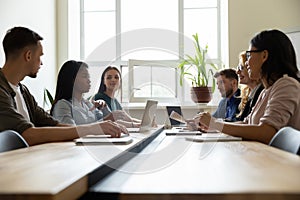 Diverse business team sitting in meeting room discussing project