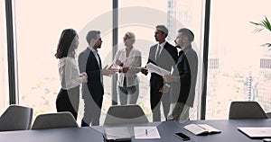 Diverse business team talking on brief meeting in conference room