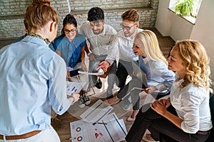 Diverse businesspeople discuss financial report in charts diagrams and graphs in meeting