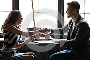 Diverse businesspeople handshake getting acquainted at meeting