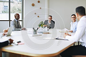 Diverse businesspeople having a meeting around a boardroom table