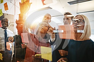 Diverse businesspeople smiling during a brainstorming session wi