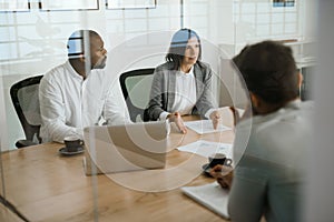 Diverse businesspeople talking together during an office meeting