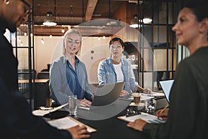 Diverse businesspeople working around a table in a modern office