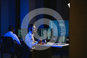 Diverse call center operators team use computers consulting clients in office