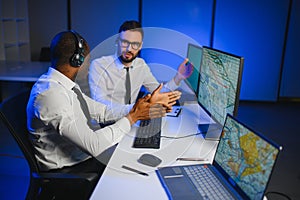 Diverse call center operators team use computers consulting clients in office