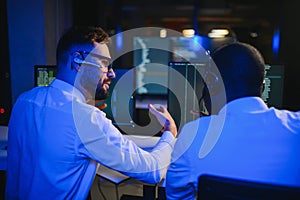Diverse call center operators team use computers consulting clients in office