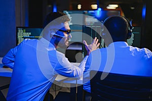 Diverse call center operators team use computers consulting clients in office