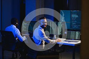 Diverse call center operators team use computers consulting clients in office
