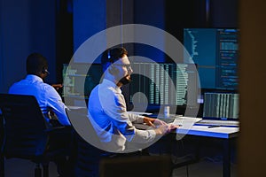 Diverse call center operators team use computers consulting clients in office