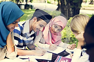 Diverse children studying at the park