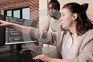 Diverse coders working on terminal window with html script