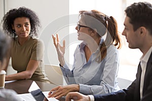 Diverse colleague brainstorm discussing ideas at briefing