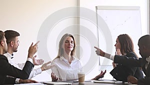 While diverse colleagues accusing and screaming pointing fingers businesswoman meditating