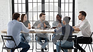 Diverse colleagues brainstorm discuss ideas at meeting