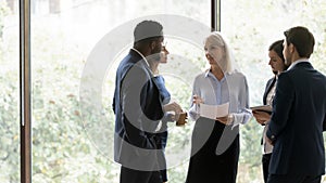 Diverse colleagues brainstorm discussing business ideas together