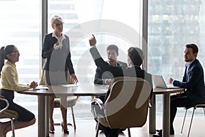 Diverse colleagues brainstorm at office business meeting