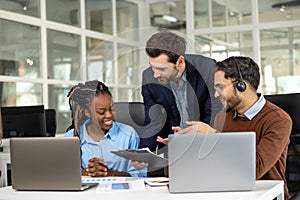 Diverse colleagues collaborating on project together