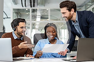 Diverse colleagues collaborating on project together