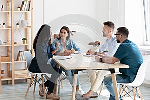 Diverse colleagues discuss business ideas at briefing